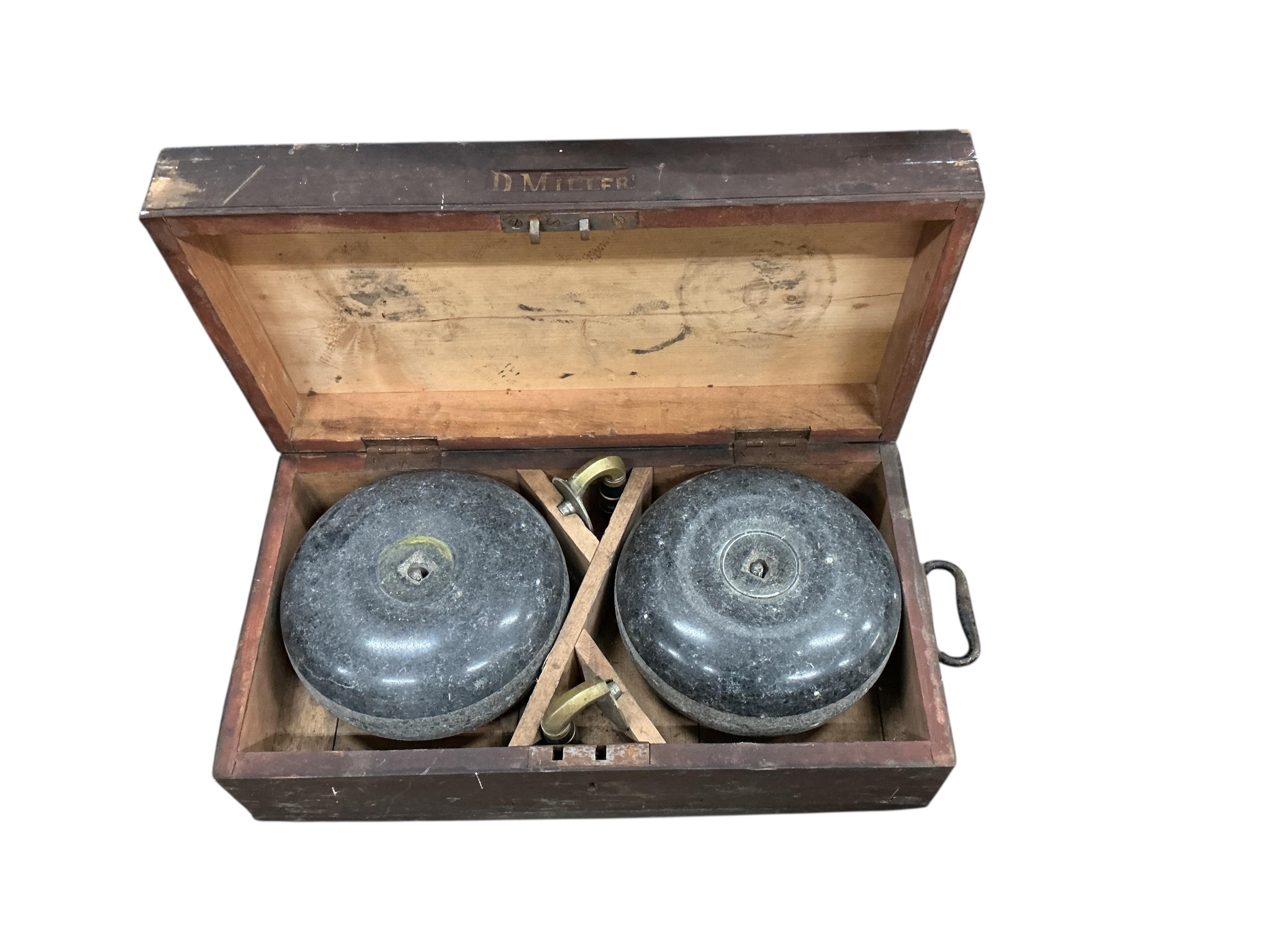 A cased pair of vintage curling stones